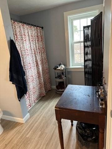 home office with light hardwood / wood-style floors