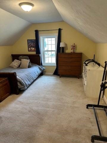 bedroom featuring light colored carpet and vaulted ceiling