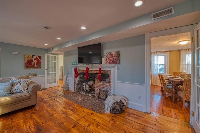 living room featuring a fireplace and light hardwood / wood-style floors