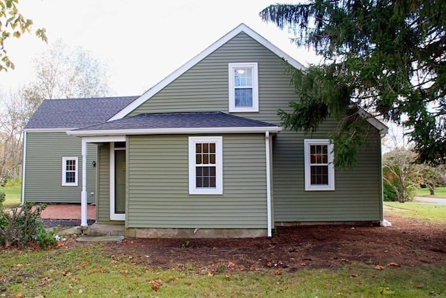 rear view of house with a yard