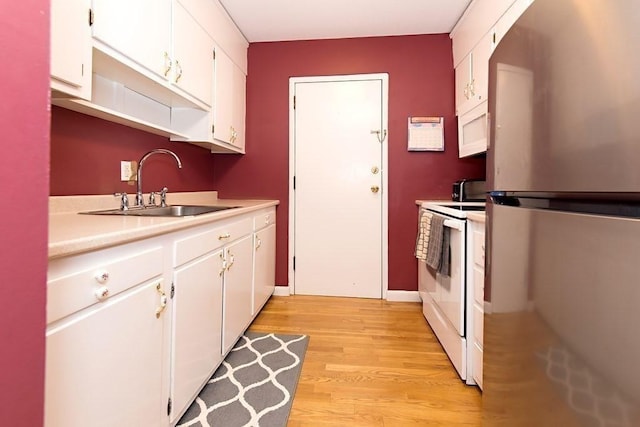 238 Rock St Unit C8, Norwood, MA 02062 - kitchen with white appliances, a sink, light countertops, white cabinets, and light wood-type flooring