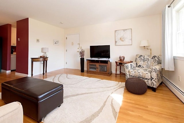238 Rock St Unit C8, Norwood, MA 02062 - living area with a baseboard radiator and light wood-style flooring
