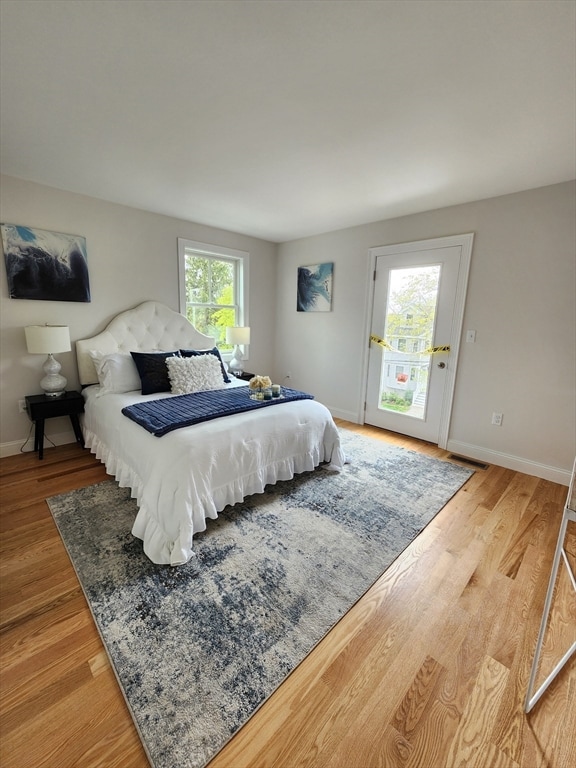 bedroom featuring hardwood / wood-style flooring and multiple windows