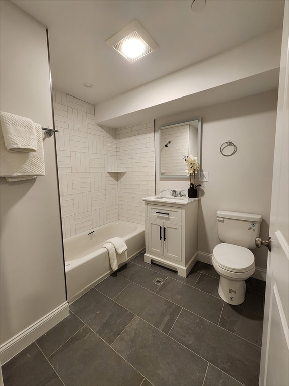 full bathroom featuring toilet, vanity, tiled shower / bath combo, and tile patterned flooring