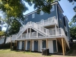 rear view of property with central AC unit and a deck