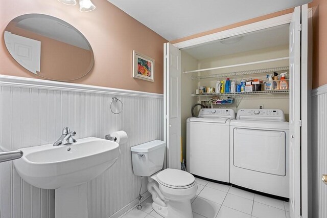 9 Summerfield Dr Unit 8, Grafton, MA 01560 - bathroom with toilet, a wainscoted wall, a sink, washer and dryer, and tile patterned floors