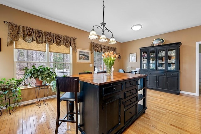 9 Summerfield Dr Unit 8, Grafton, MA 01560 - kitchen with butcher block countertops, a breakfast bar area, light wood-type flooring, and dark cabinetry
