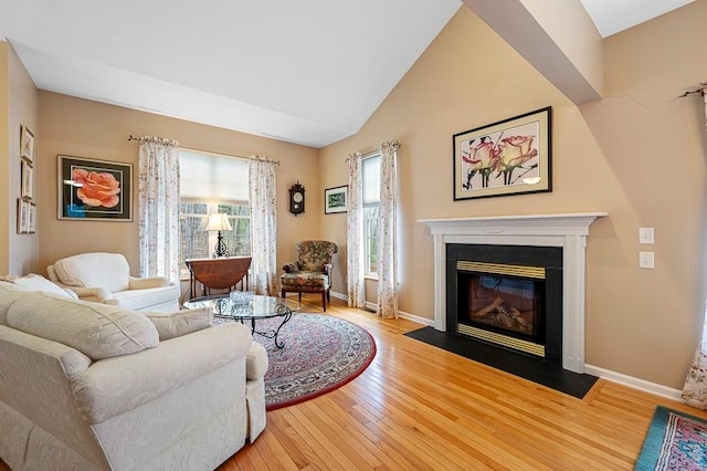 9 Summerfield Dr Unit 8, Grafton, MA 01560 - living area with a fireplace with flush hearth, vaulted ceiling, baseboards, and hardwood / wood-style flooring