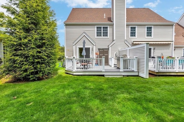 17 Hampton Ct Unit 17, Mashpee, MA 02649 - rear view of house with a chimney, a wooden deck, and a lawn