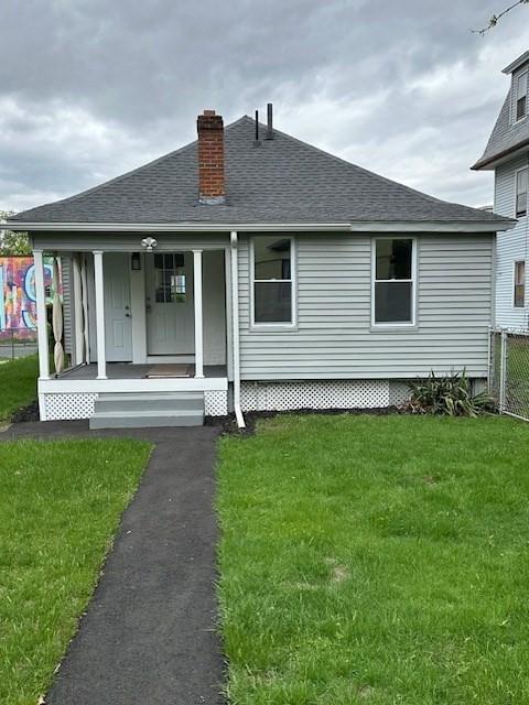 423 Orange St, Springfield, MA 01108 - rear view of property featuring a porch, a chimney, and roof with shingles