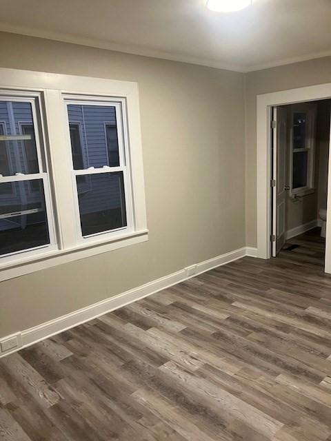 423 Orange St, Springfield, MA 01108 - unfurnished room with dark wood-type flooring, crown molding, and baseboards