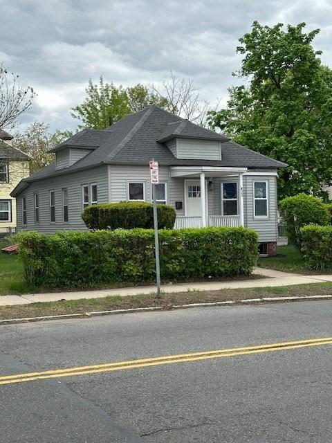 423 Orange St, Springfield, MA 01108 - view of front of home with a shingled roof and a porch