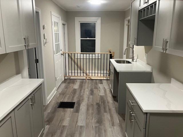 423 Orange St, Springfield, MA 01108 - laundry area featuring a sink, dark wood finished floors, and ornamental molding