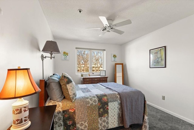 carpeted bedroom with a textured ceiling and ceiling fan