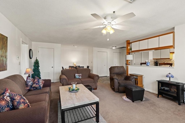 carpeted living room featuring ceiling fan