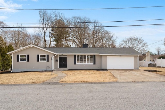 ranch-style house featuring a garage, a chimney, driveway, and fence