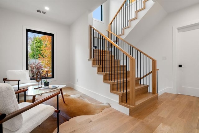 sitting room with baseboards, visible vents, wood finished floors, and recessed lighting