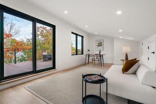 bedroom with vaulted ceiling, light wood finished floors, baseboards, and recessed lighting