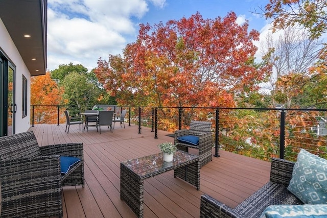 wooden terrace with outdoor dining space