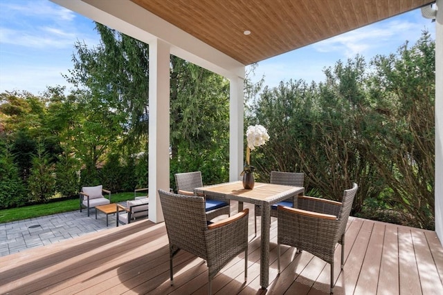 wooden terrace featuring outdoor dining space