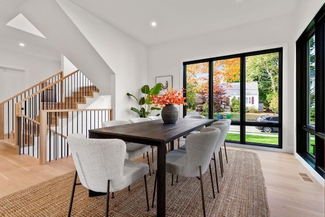 dining space with stairway, recessed lighting, visible vents, and light wood-style floors