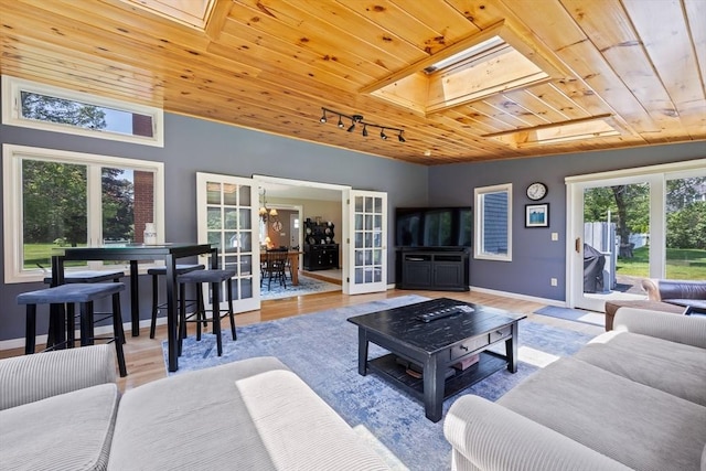 88 Amelia Way, Barnstable, MA 02648 - living area with wooden ceiling, healthy amount of natural light, track lighting, wood finished floors, and a skylight