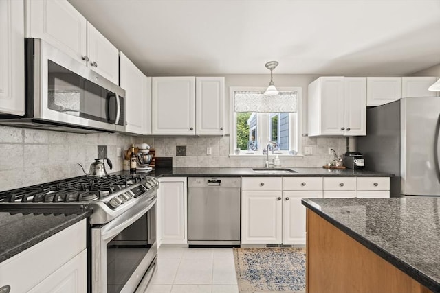 88 Amelia Way, Barnstable, MA 02648 - kitchen featuring appliances with stainless steel finishes, white cabinets, backsplash, light tile patterned floors, and dark stone counters