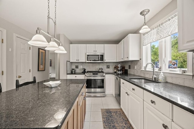 88 Amelia Way, Barnstable, MA 02648 - kitchen with stainless steel appliances, backsplash, white cabinets, and pendant lighting