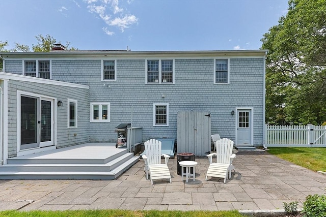 88 Amelia Way, Barnstable, MA 02648 - rear view of house featuring a patio area, a wooden deck, an outdoor fire pit, and a chimney