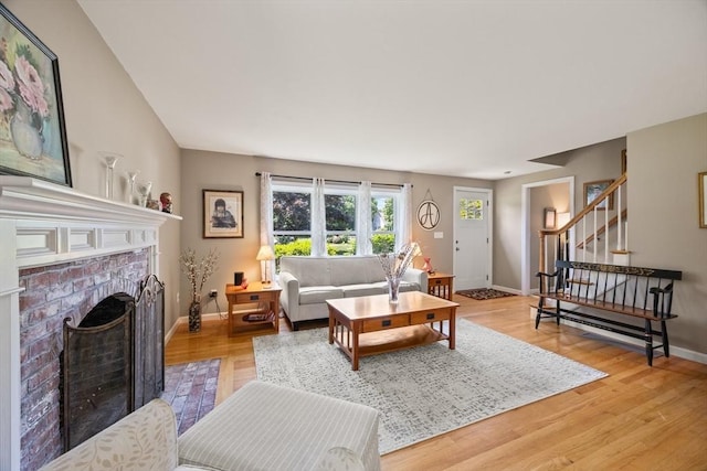 88 Amelia Way, Barnstable, MA 02648 - living room featuring stairs, light wood-type flooring, and a brick fireplace