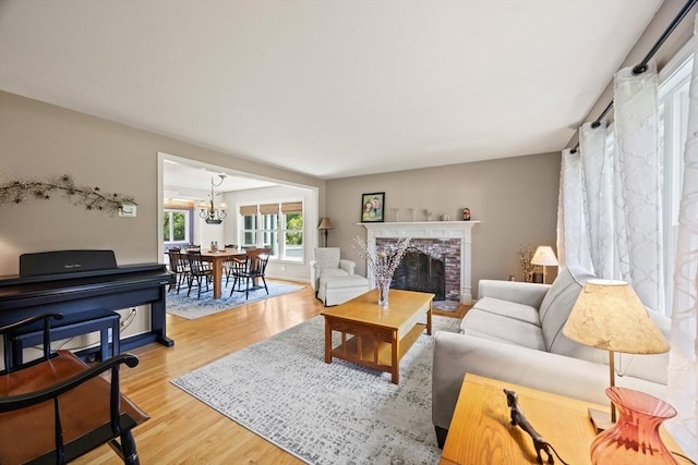 88 Amelia Way, Barnstable, MA 02648 - living area with light wood-style flooring, a chandelier, and a fireplace