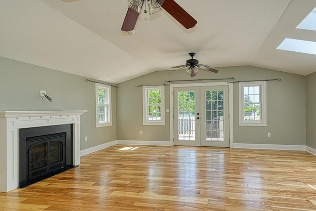 14 Mountain Ave, Marlborough, MA 01752 - unfurnished living room featuring ceiling fan, lofted ceiling, light wood-style flooring, a skylight, and baseboards