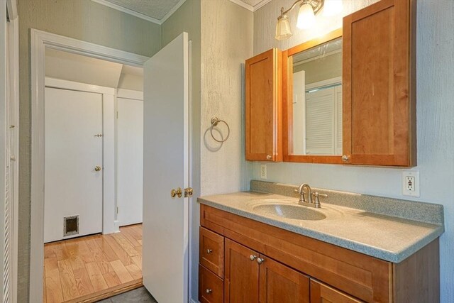 14 Mountain Ave, Marlborough, MA 01752 - bathroom with crown molding, vanity, and wood finished floors