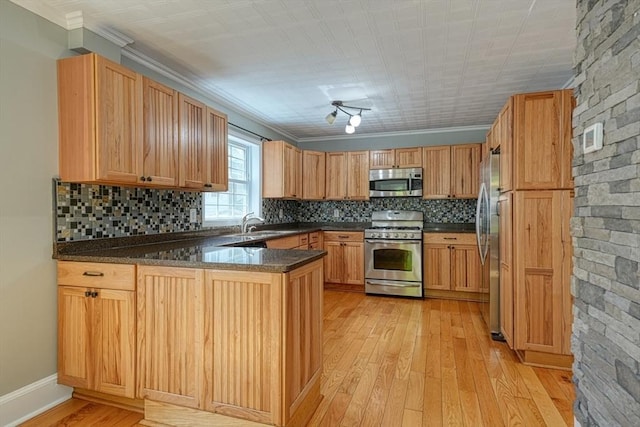 14 Mountain Ave, Marlborough, MA 01752 - kitchen with stainless steel appliances, a peninsula, light wood-style flooring, decorative backsplash, and ornamental molding