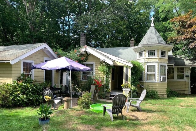 rear view of property with a yard