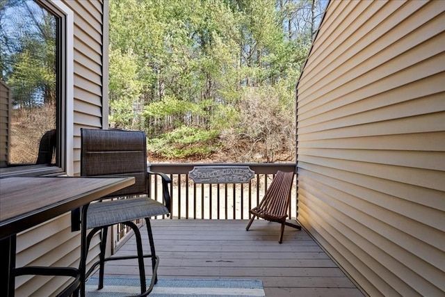 wooden terrace featuring outdoor dining area