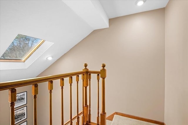 staircase with lofted ceiling with skylight, recessed lighting, and baseboards