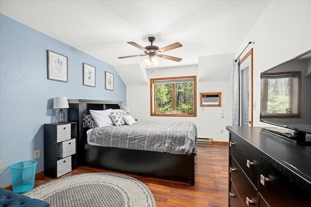 bedroom featuring dark wood-type flooring, a wall unit AC, a baseboard radiator, baseboards, and ceiling fan