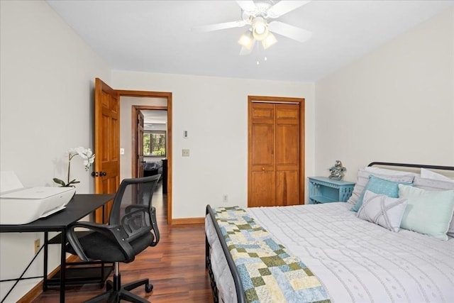 bedroom with dark wood finished floors, a ceiling fan, and baseboards