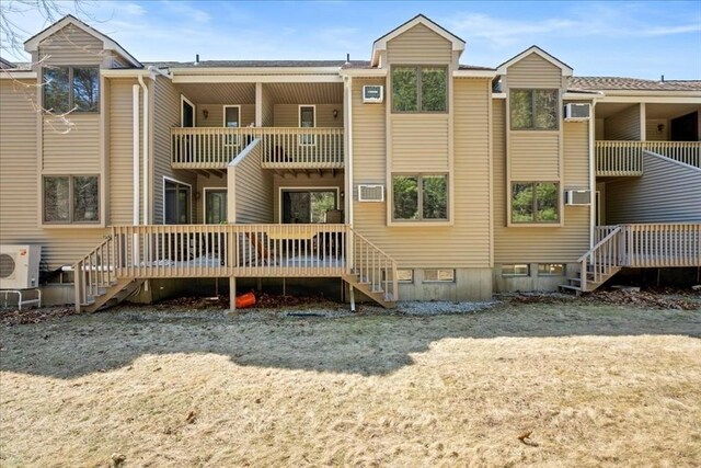 rear view of house with stairs, a balcony, and ac unit