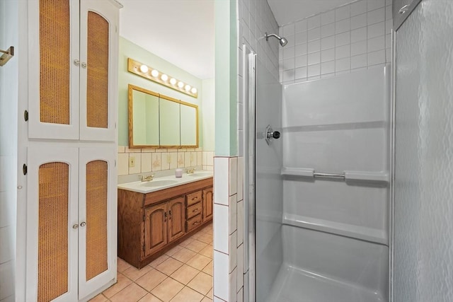 bathroom featuring a sink, tile patterned flooring, and a stall shower