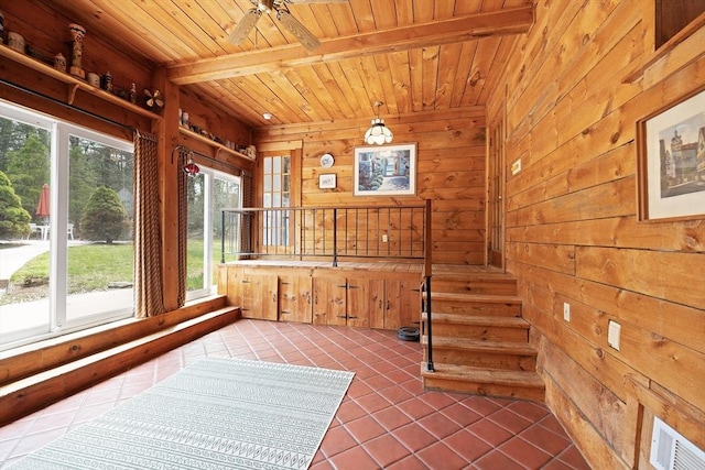 unfurnished sunroom with visible vents and beam ceiling