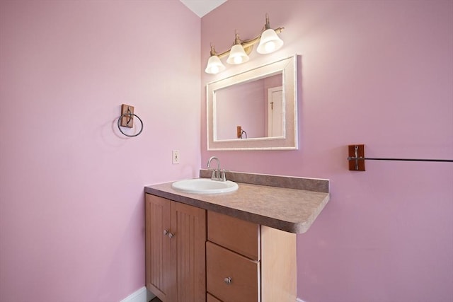 bathroom with baseboards and vanity