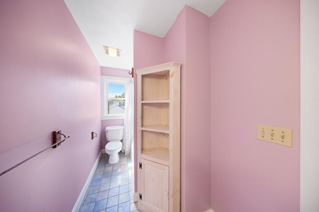 bathroom featuring visible vents, baseboards, and toilet