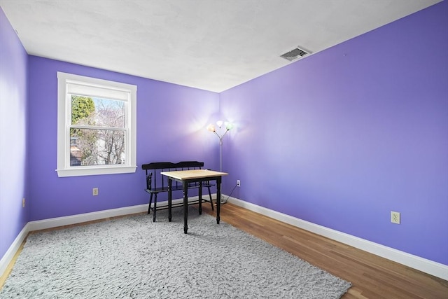 office area featuring baseboards, wood finished floors, and visible vents