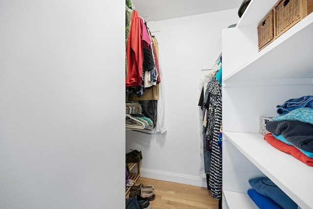 walk in closet featuring light wood finished floors