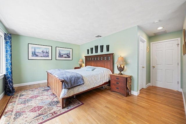bedroom with attic access, visible vents, baseboards, recessed lighting, and light wood-style floors