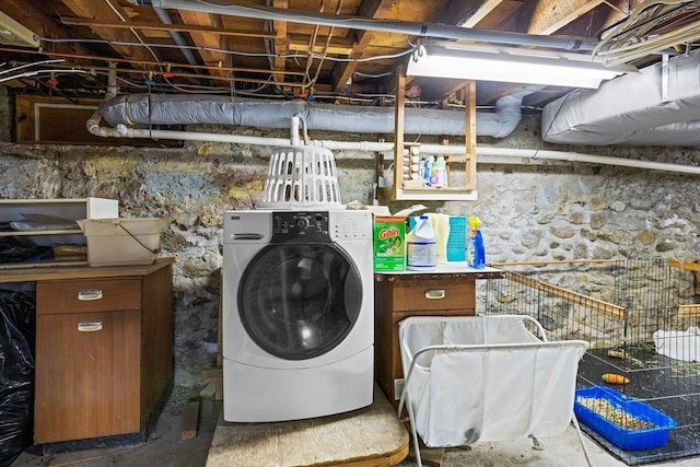 clothes washing area with washing machine and clothes dryer and laundry area