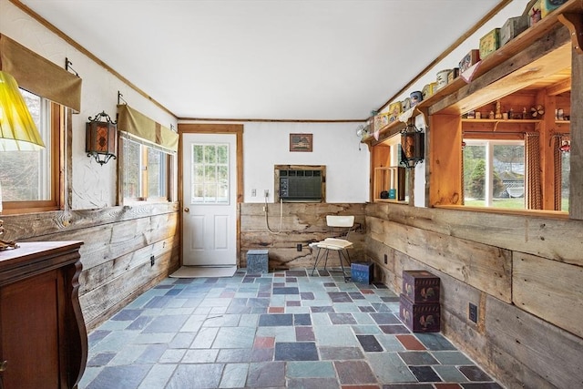 bathroom with stone finish flooring, vanity, and ornamental molding