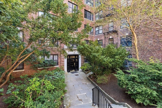 property entrance featuring brick siding
